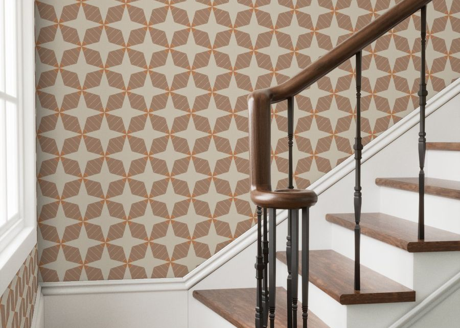 Staircase with wooden steps and a geometric patterned wall.