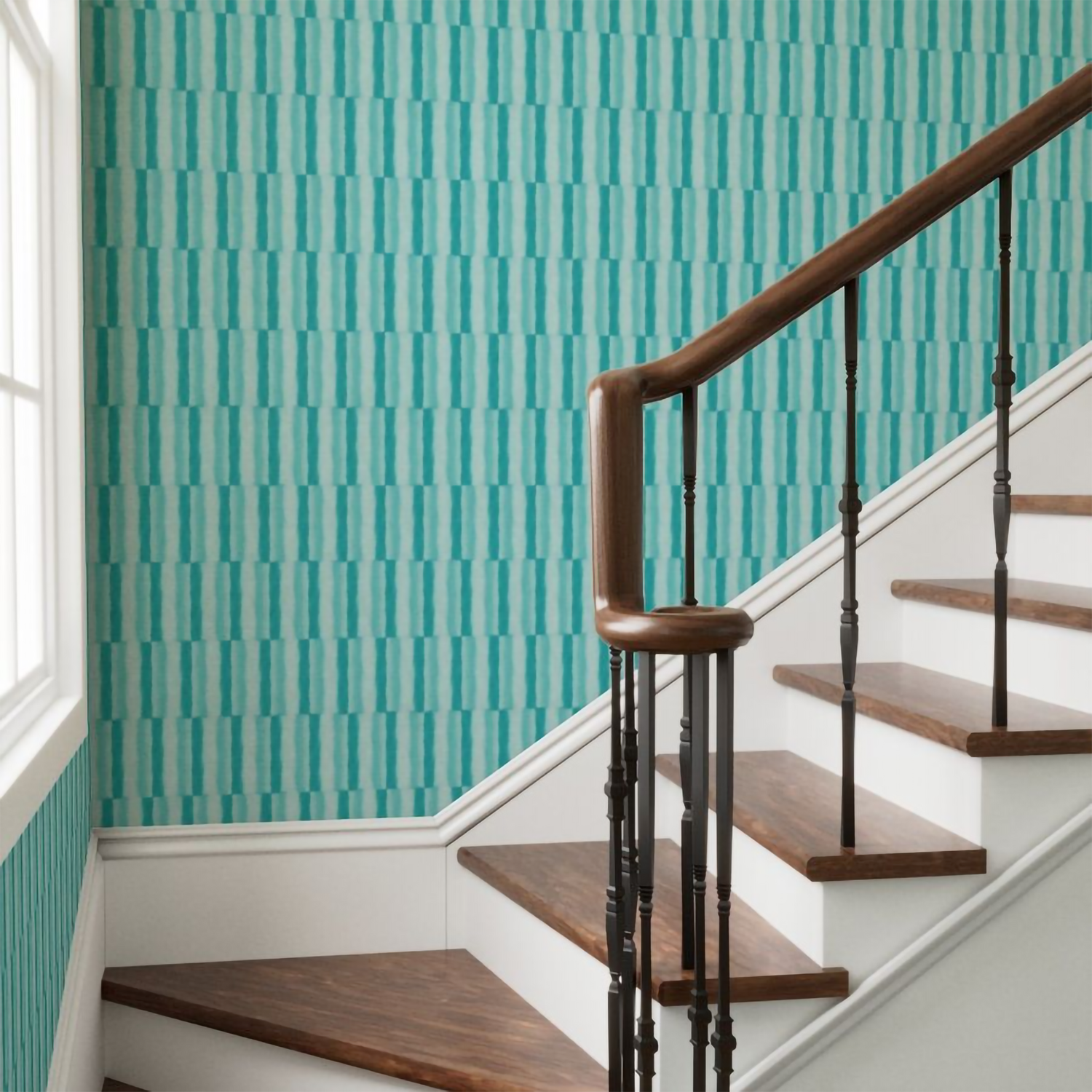 Staircase with wooden steps and a dark wooden handrail against a teal patterned wall.