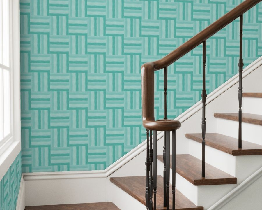 Staircase with wooden railings against a teal geometric-patterned wall.