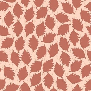 Pattern of brown leaves on a beige background