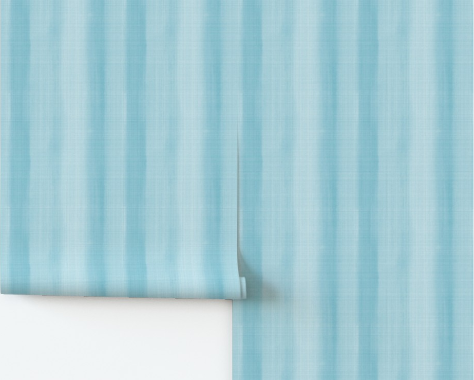 Roll of blue striped wallpaper on a white background