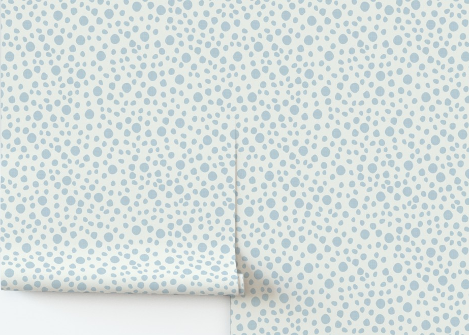 Patterned paper with small blue dots on a white background