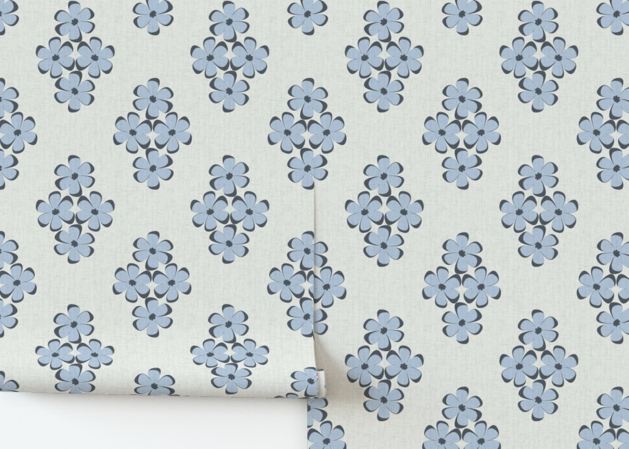 Roll of fabric with blue floral pattern on a white background