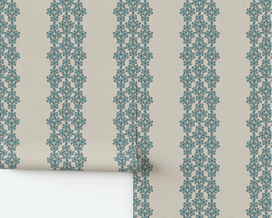 Roll of wallpaper with blue floral stripes on a beige background