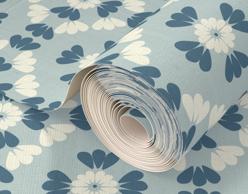 Roll of wallpaper with blue and white floral geometric mosaic pattern on a matching background.