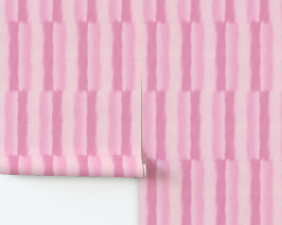 Roll of pink textured wallpaper on a white background
