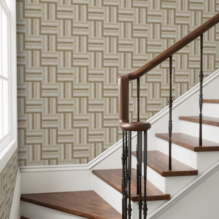 Staircase with wooden steps and handrail against a patterned wall of sandy beige basketweave watercolor stripes.