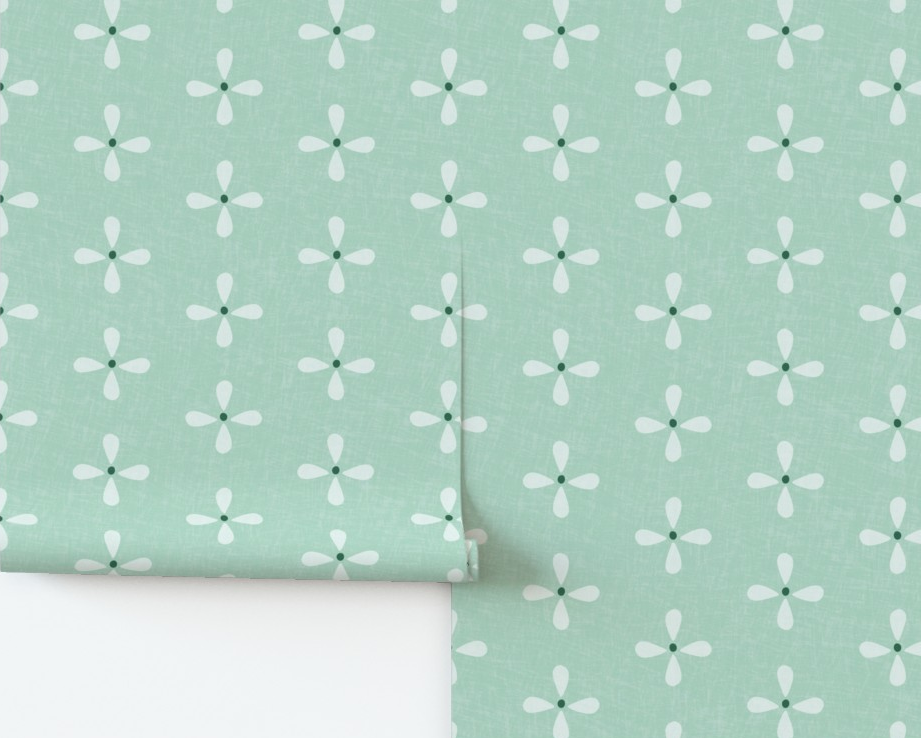 Roll of green wallpaper with white floral pattern.